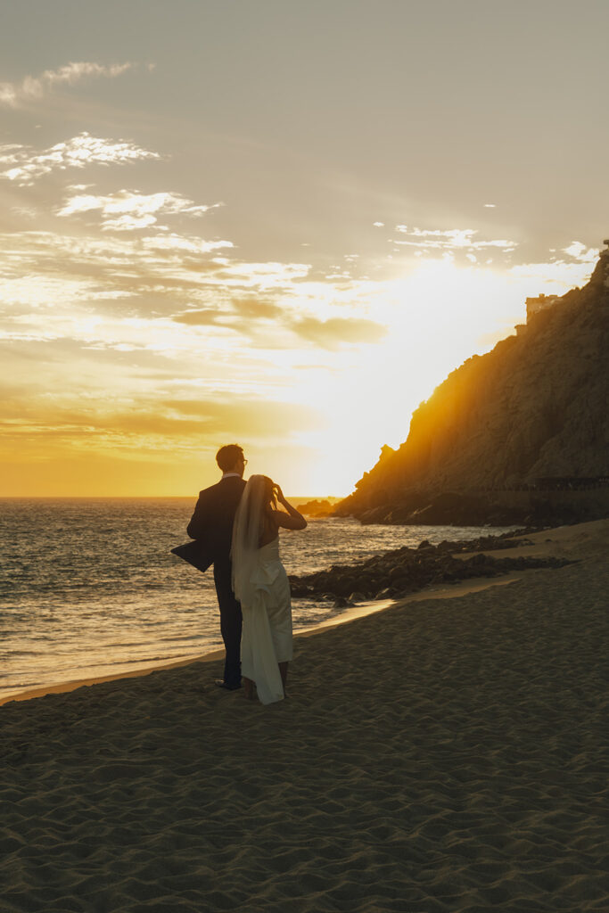 couple watches beach sunset at Mexico destination wedding