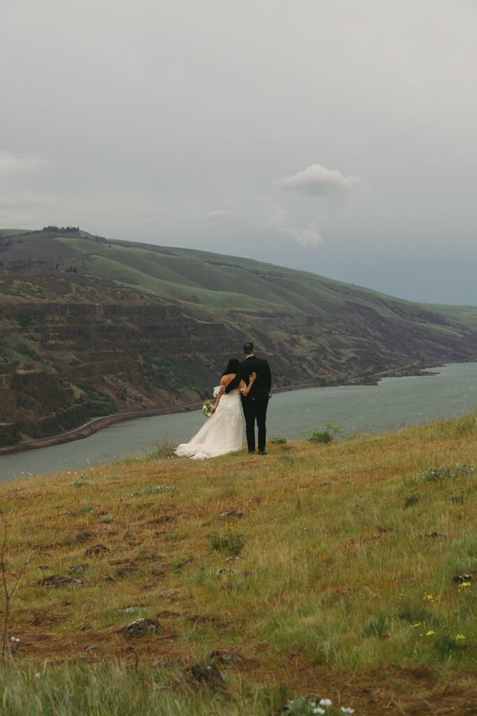 couple stands together at outdoor elopement overlook