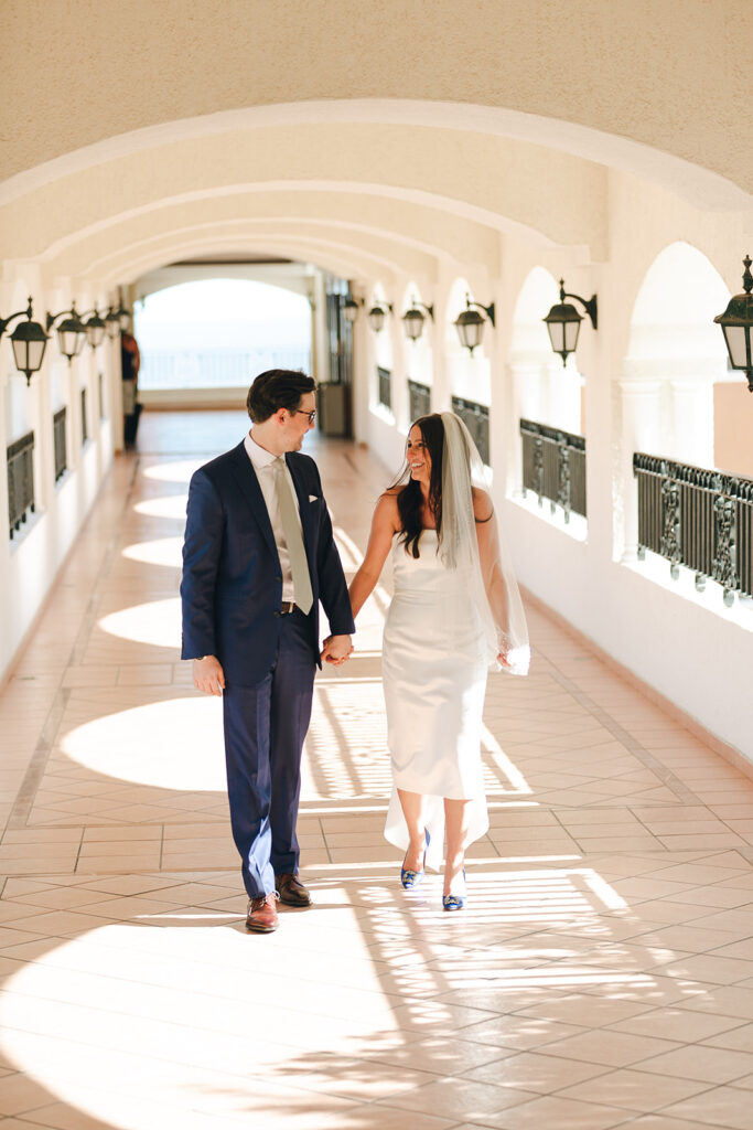 couple walks along corridor at Mexico destination wedding