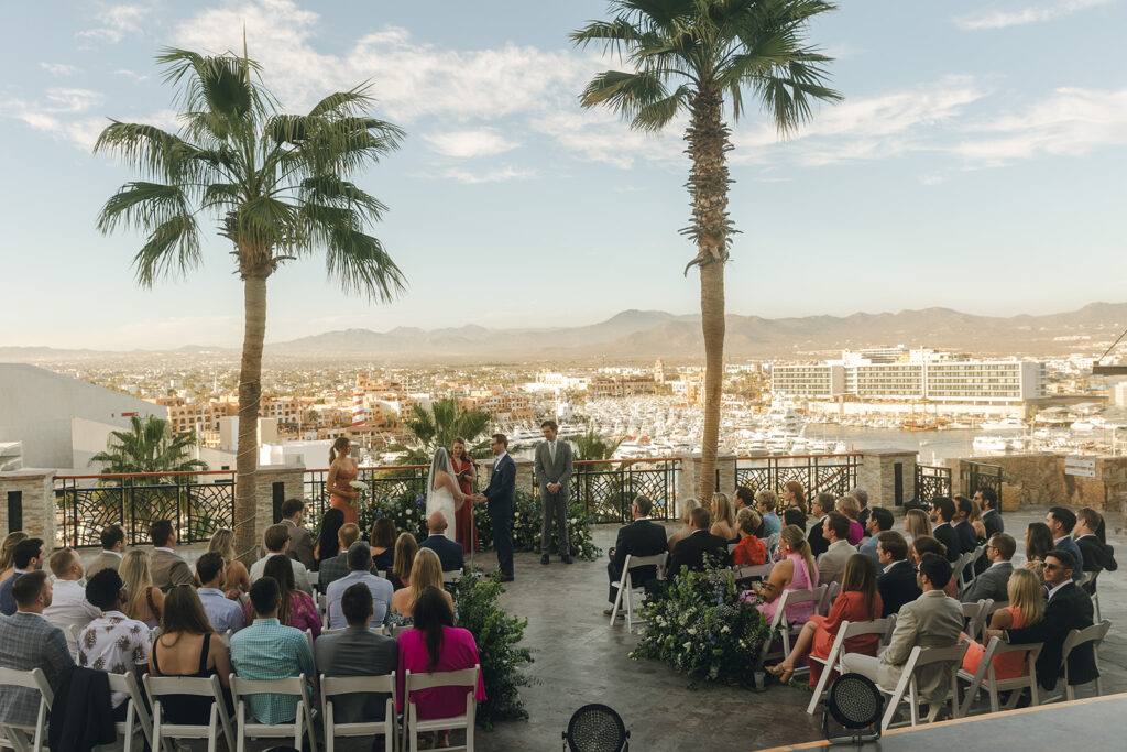 couple exchanges vows at spot overlooking city at Mexico wedding