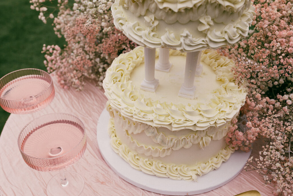 wedding cake and pink champagne on pink tablecloth