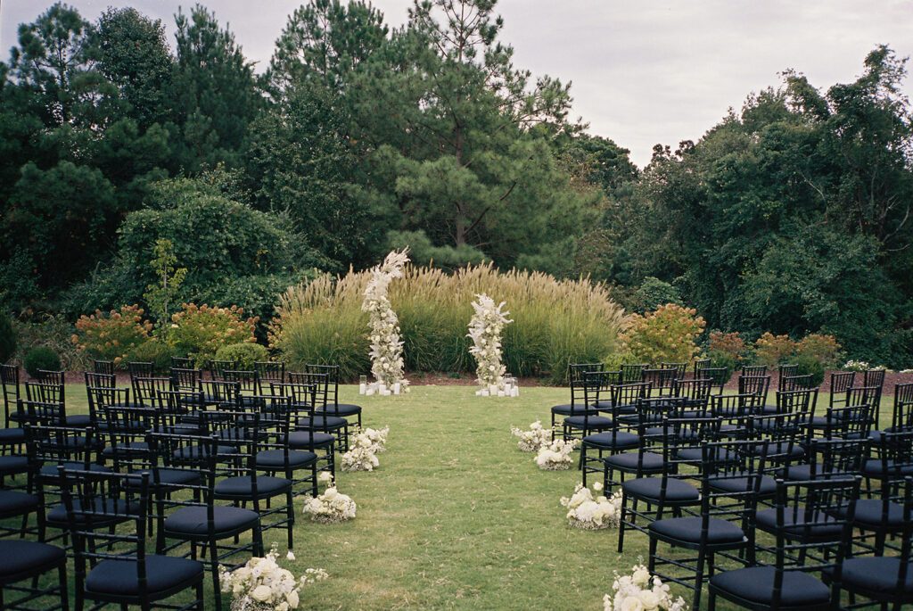 outdoor wedding ceremony beside trees at Raleigh North Carolina wedding venues