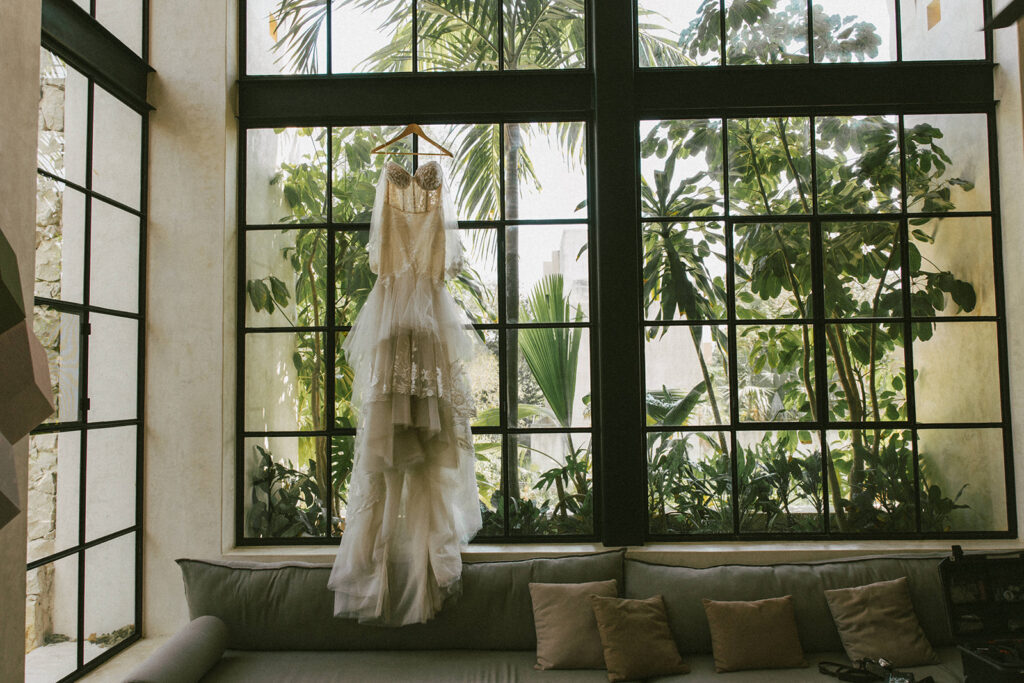 wedding dress hangs over windows captured by traveling photographers