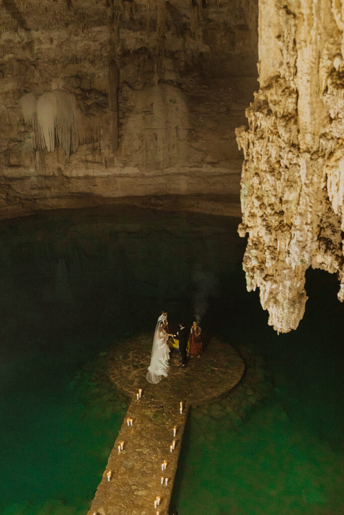 couple gets married in a water-filled caved photographed by traveling photographers