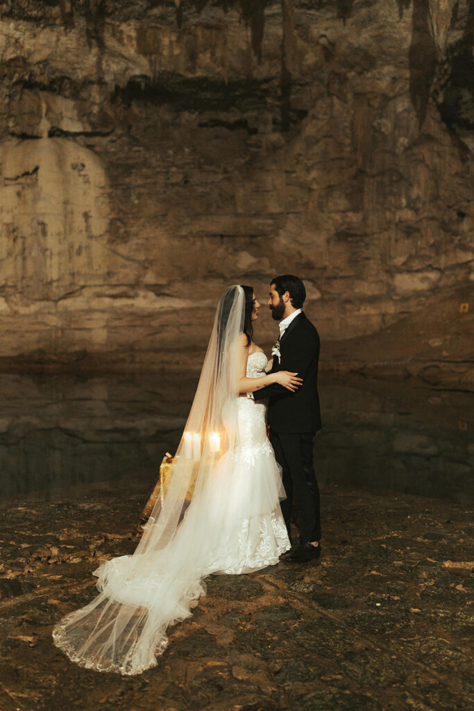 couple has wedding ceremony in cave photographed by traveling photographers