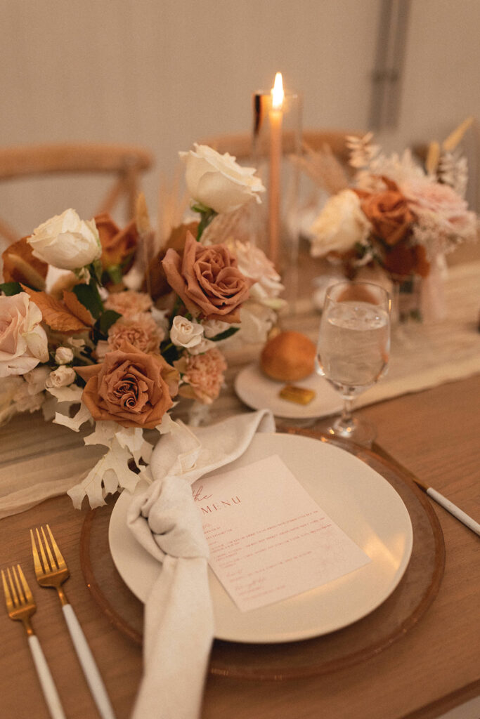pink and white flowers on wedding reception table