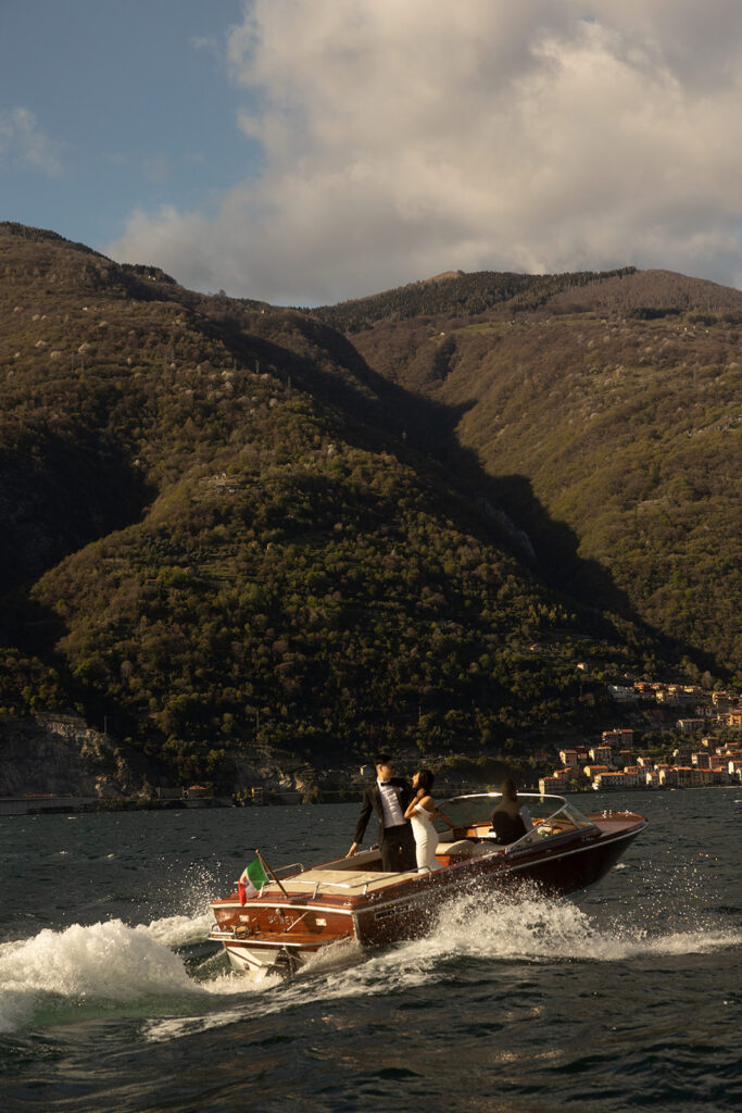 couple takes boat road in lake photographed by destination wedding photographer