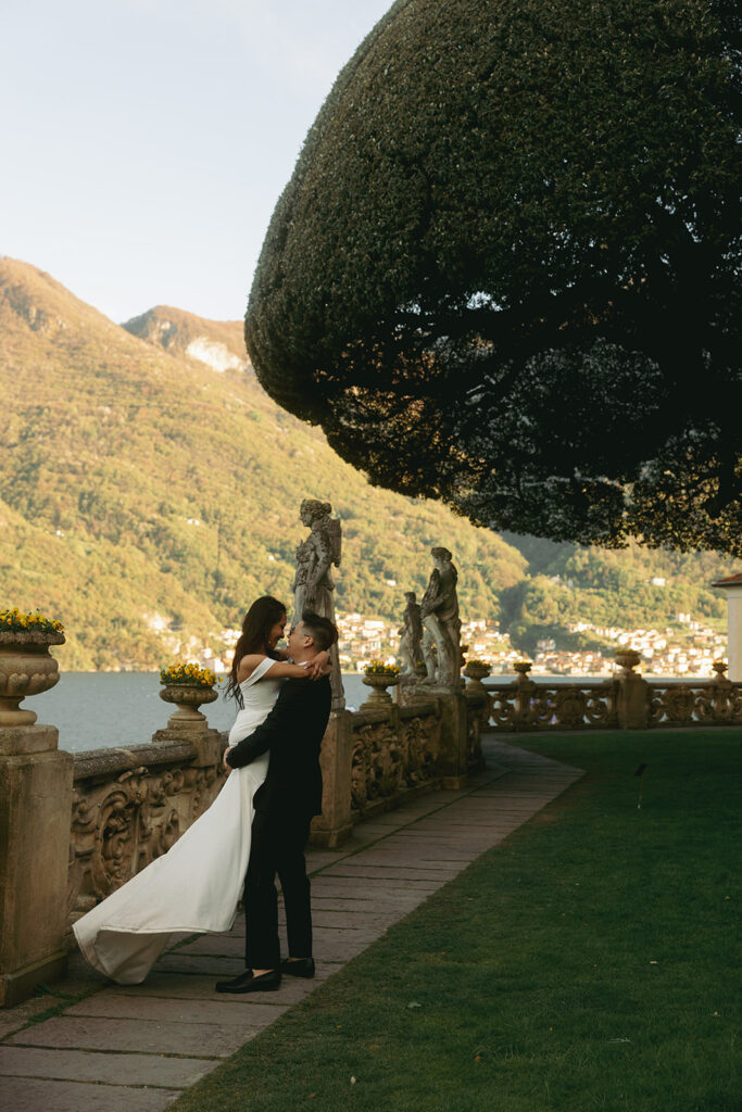 couple embraces beside Lake Como at Italy wedding 