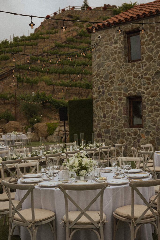 stone building with twinkle lights and wedding reception decor