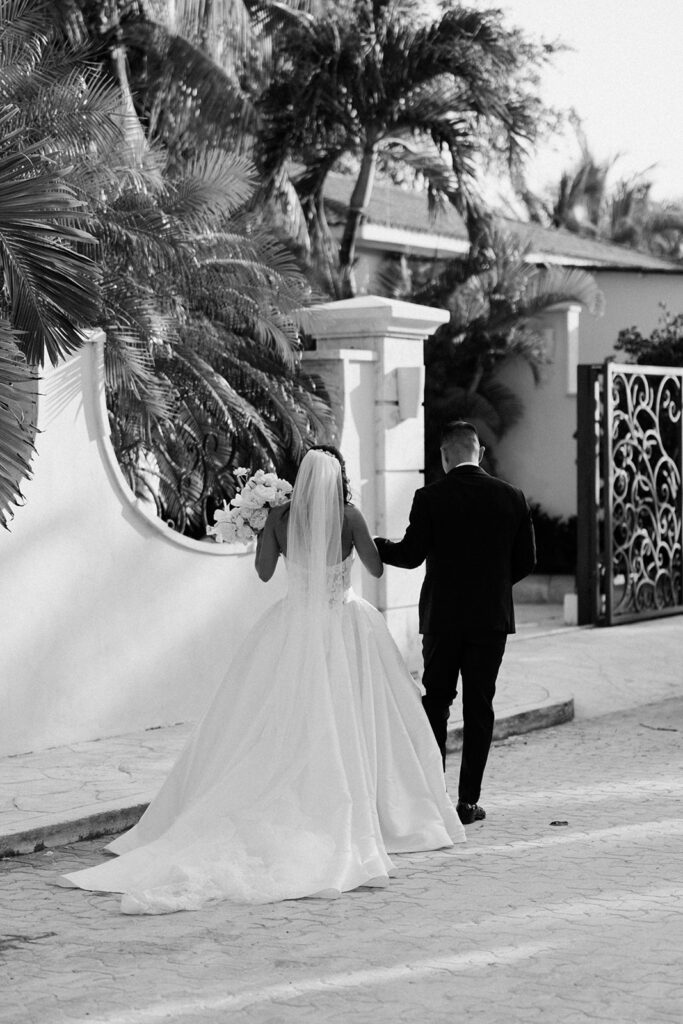 couple walks through street at Mexico wedding venue