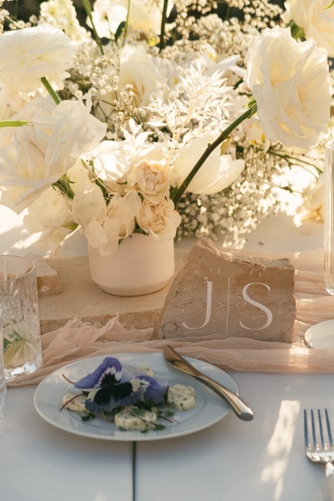 white flower and stone wedding reception decor