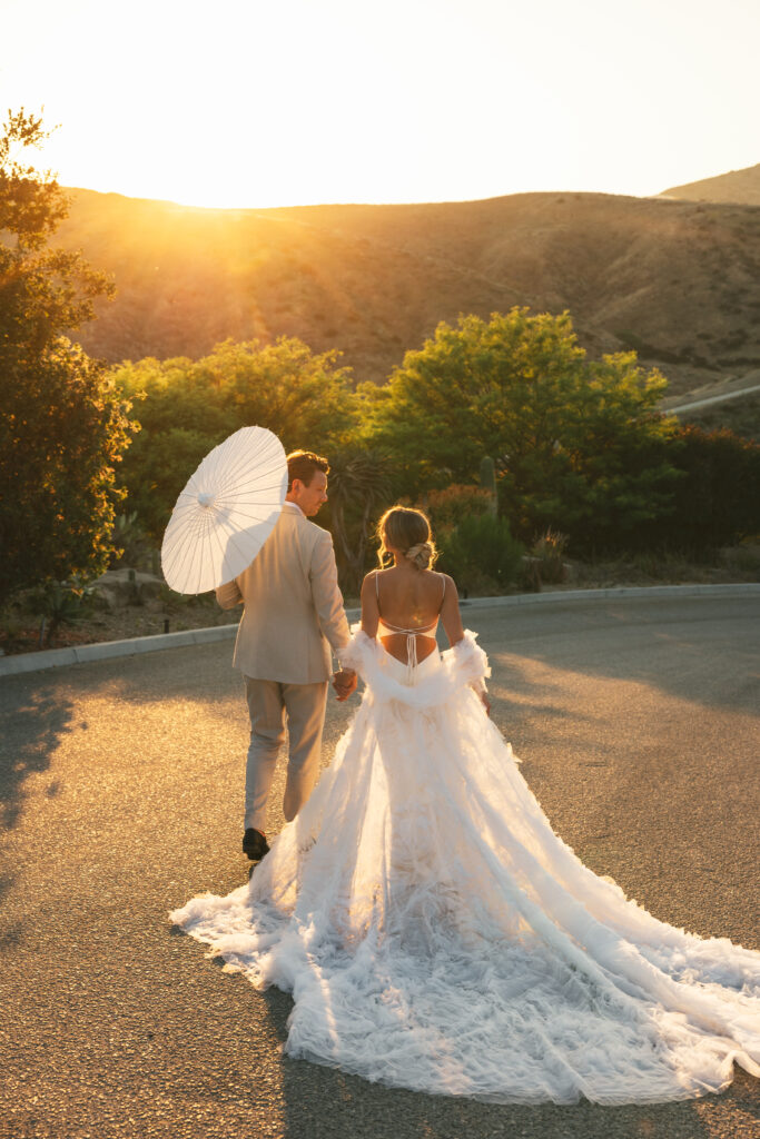 couple walks at sunset outdoor summer wedding