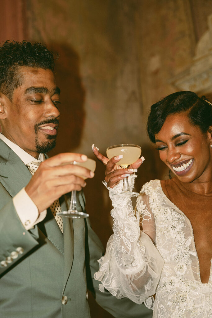 couple cheers their drinks together at Hotel Peter and Paul New Orleans wedding