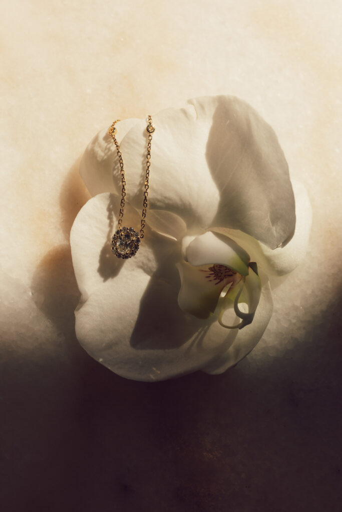 bridal necklace laying on an orchid