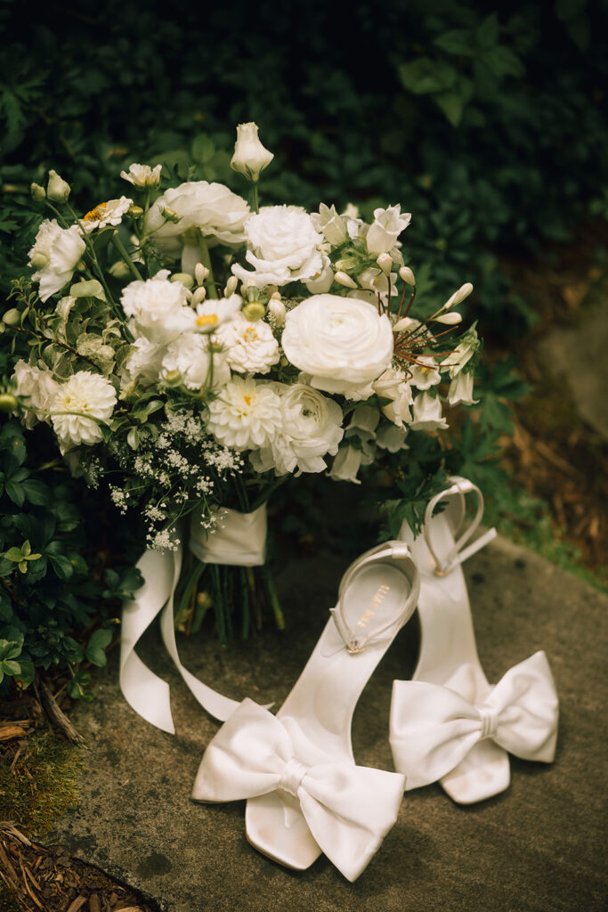 white wedding bouquet and white wedding shoes