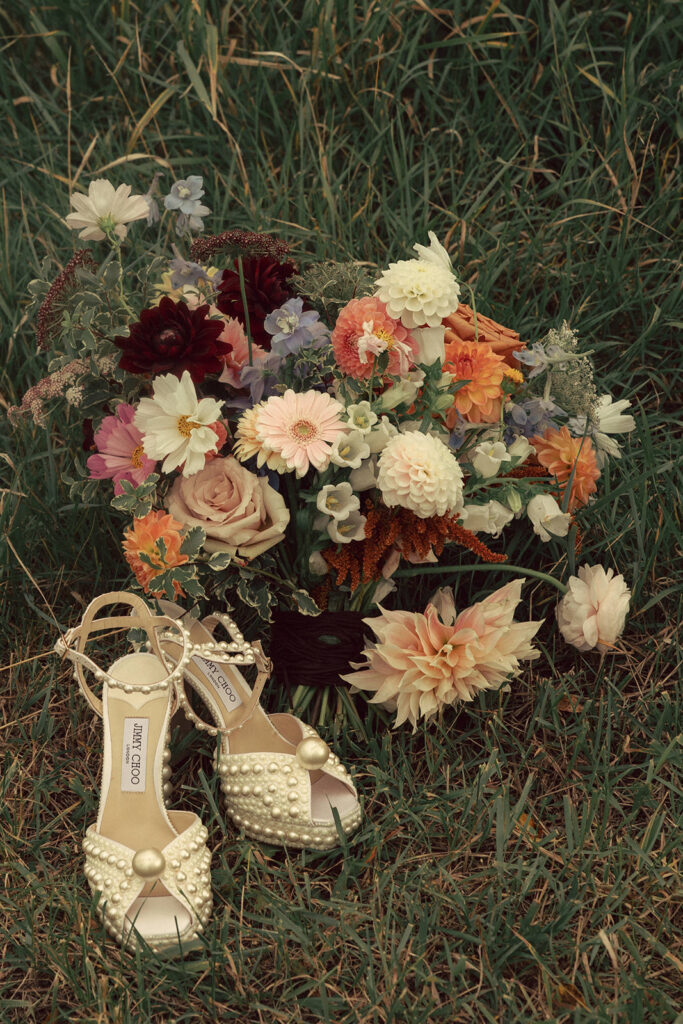 pearl-studded wedding shoes with wildflower bouquet