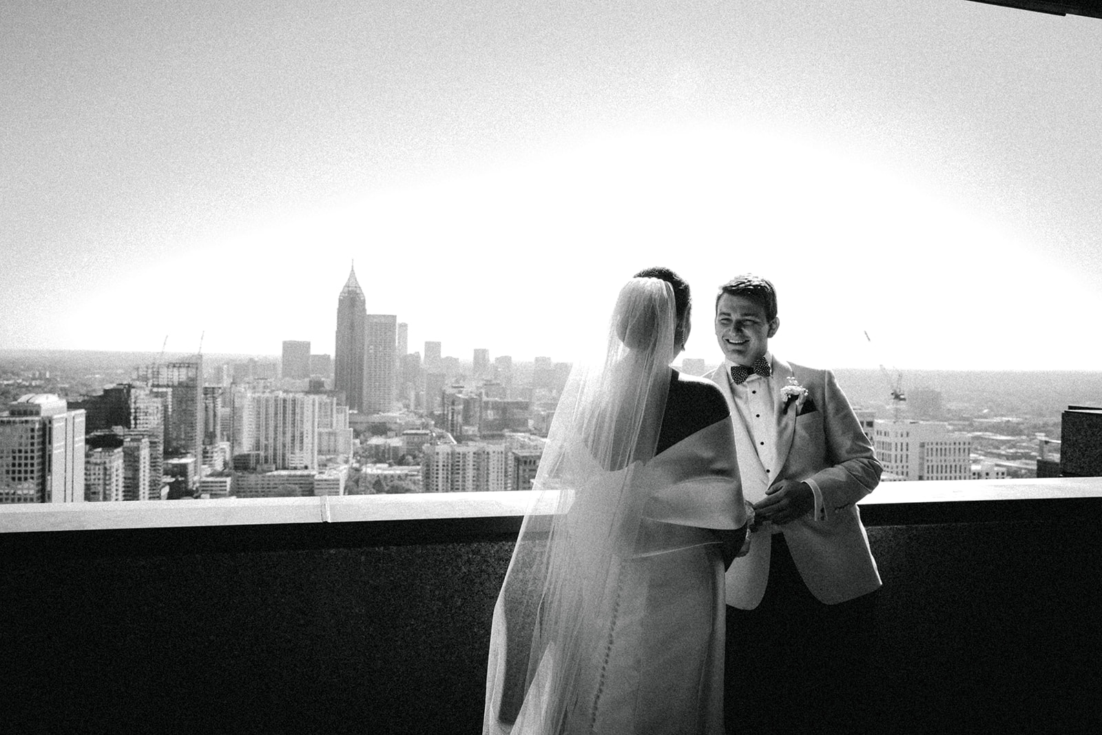 couple stands on rooftop at hotel wedding venue