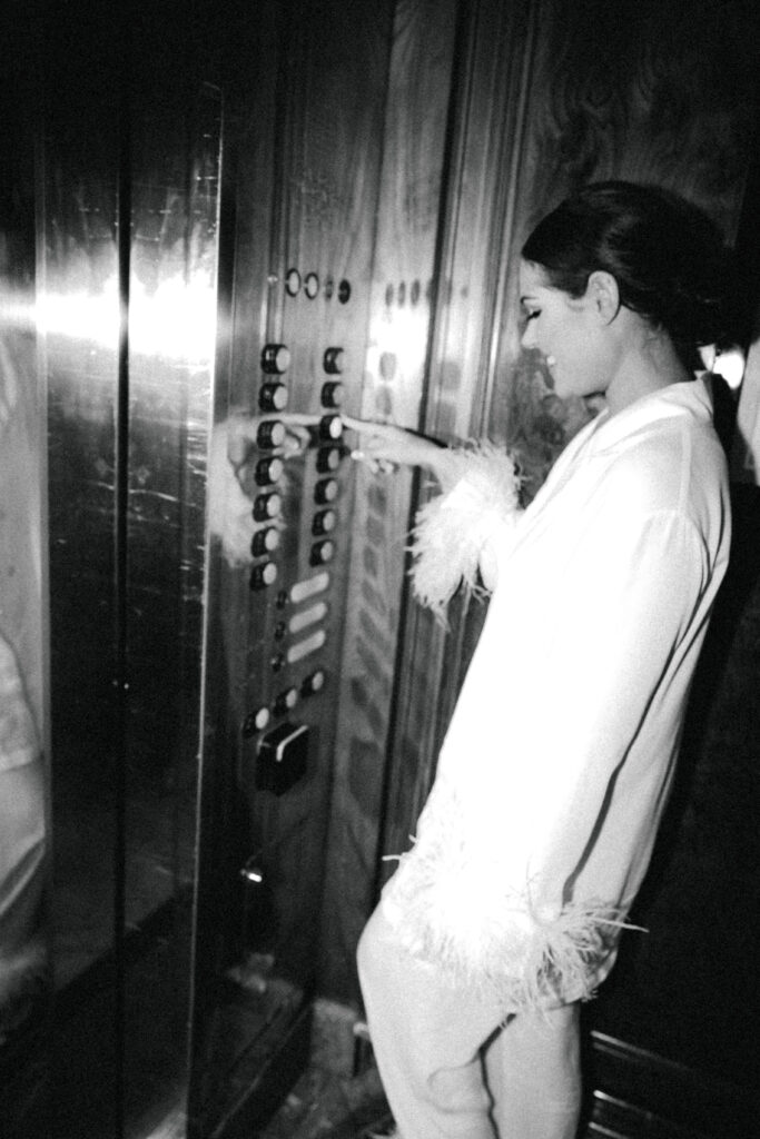 bride in elevator pressing button