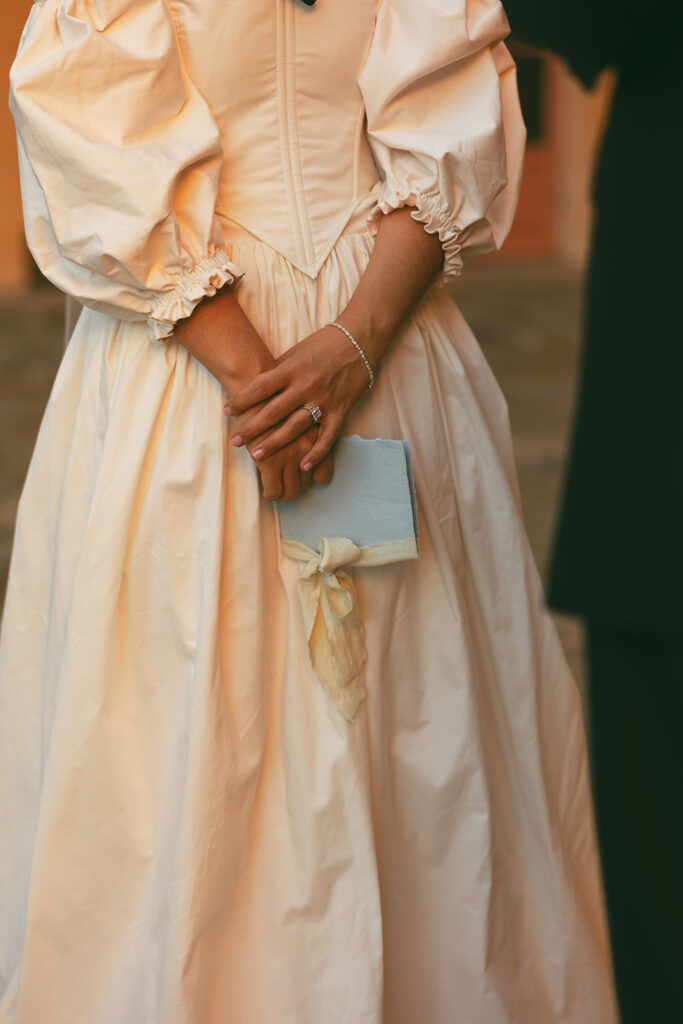 bride holds wedding vow book
