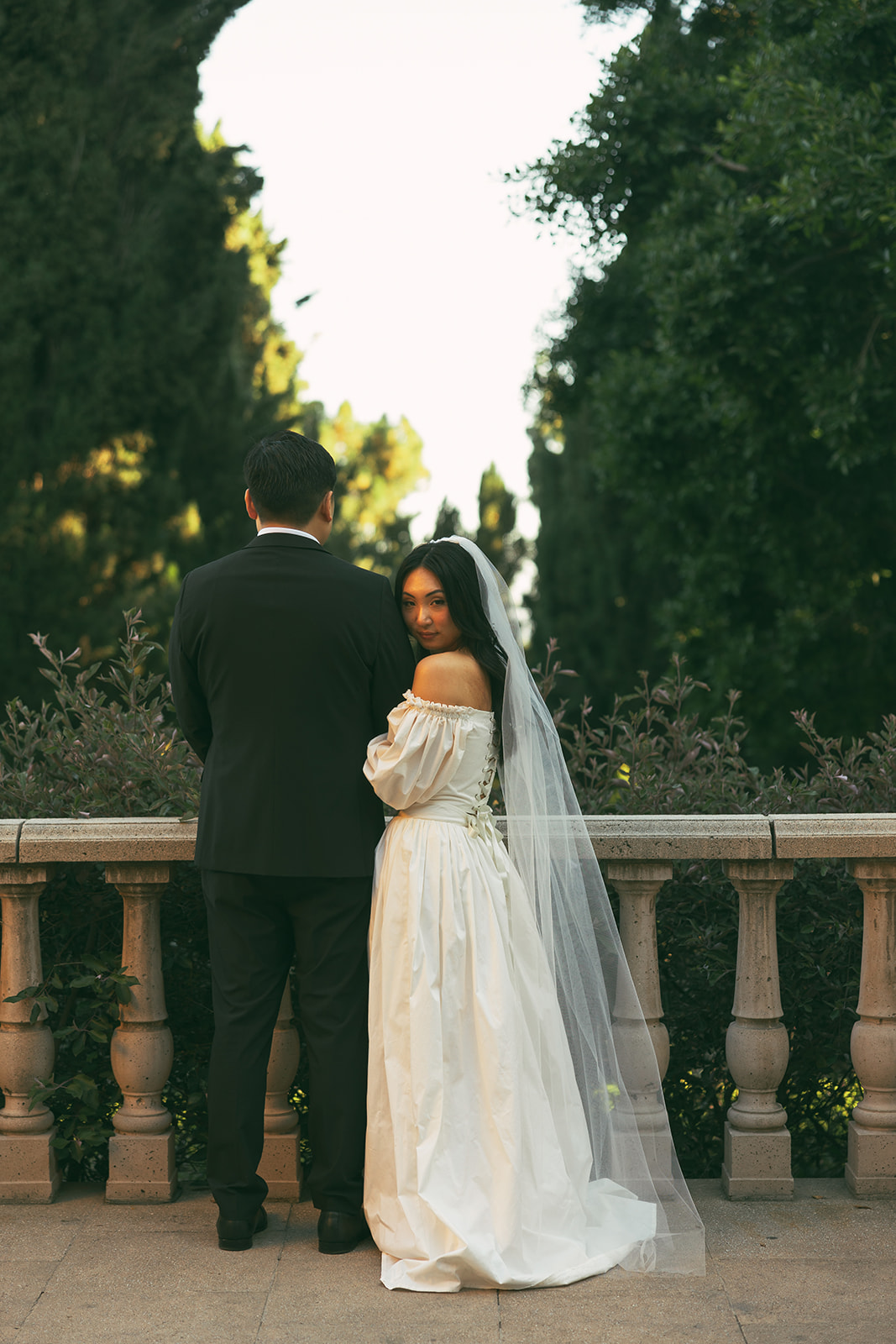 couple stands at garden wedding venue