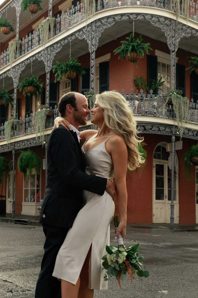 couple embraces on the streets of New Orleans at engagement session