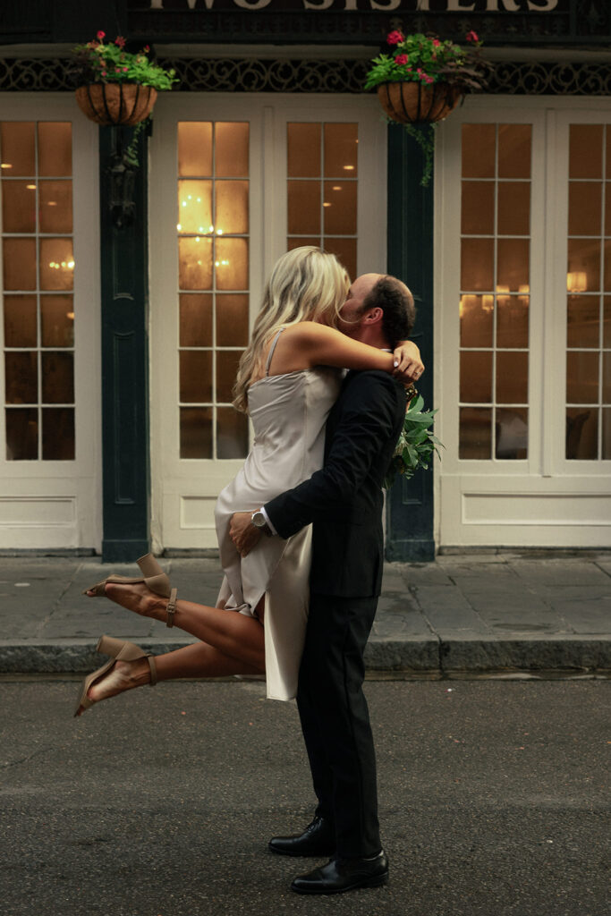 couple embraces on the streets of New Orleans at engagement session