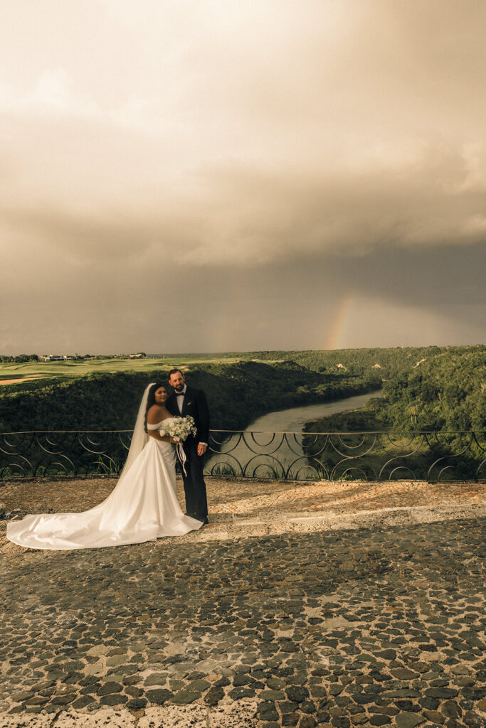 couple stands under rainbow at Dominican Republic destination wedding