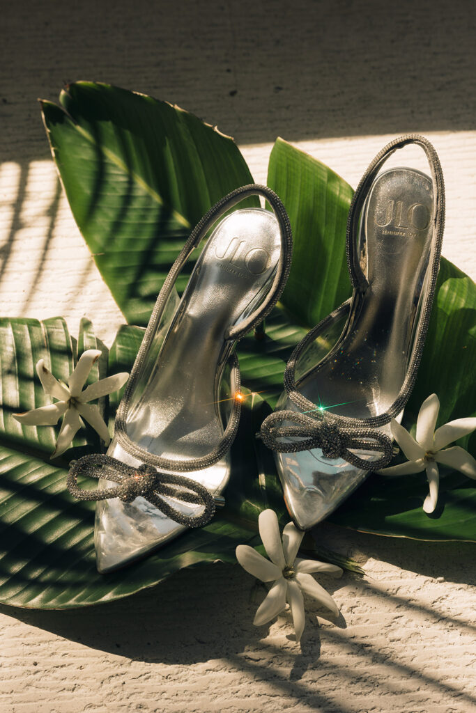 wedding shoes on flowers and green leaves