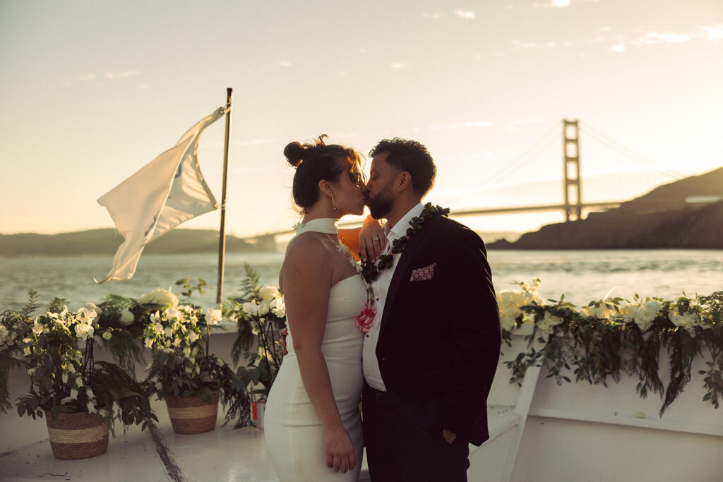 couple kisses on boat at San Francisco elopement