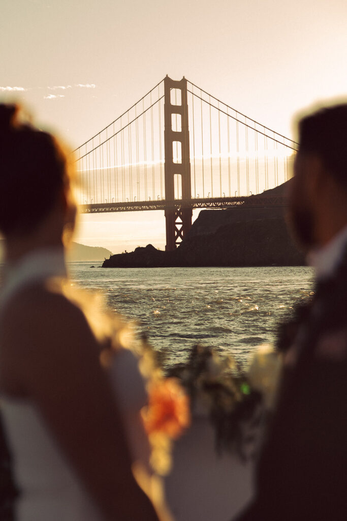couple watches sunset from boat at San Francisco elopement