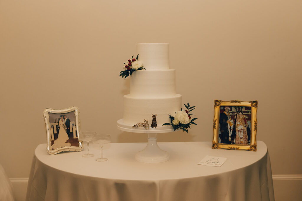 white wedding cake with cat figures