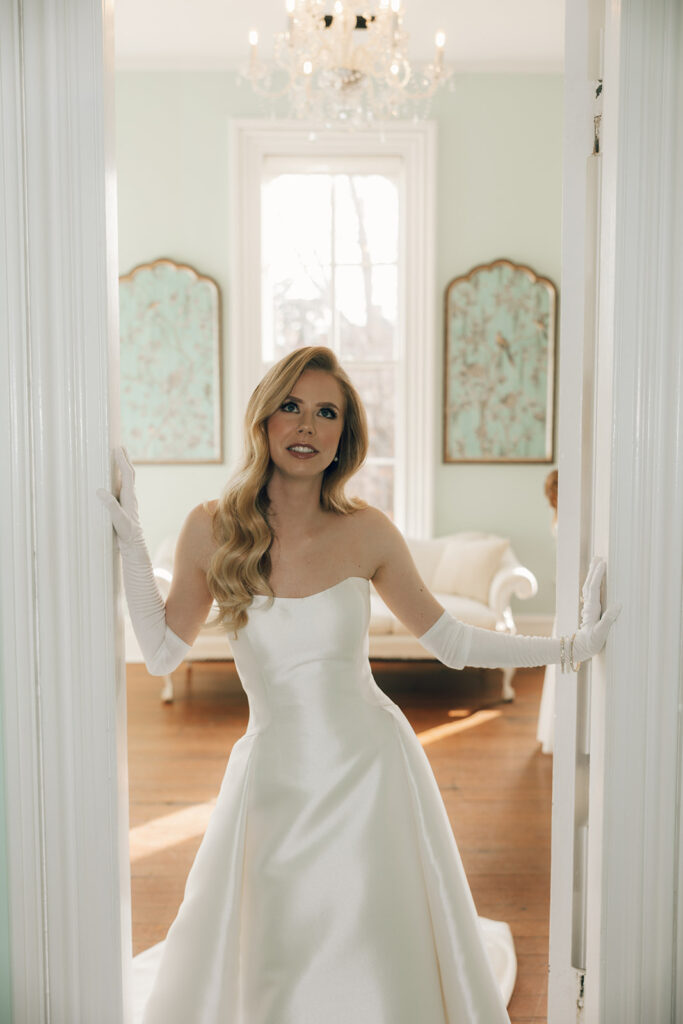 bride stands in doorway at The Merrimon-Wynne House