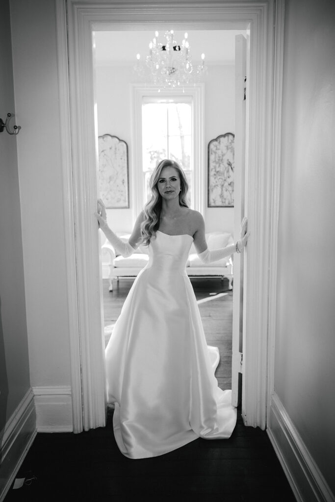 bride stands in doorway at The Merrimon-Wynne House