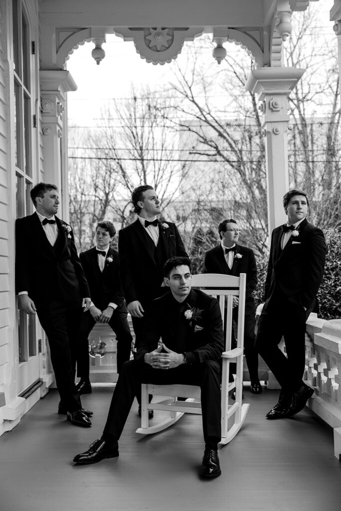 groomsmen pose on front porch at The Merrimon-Wynne House