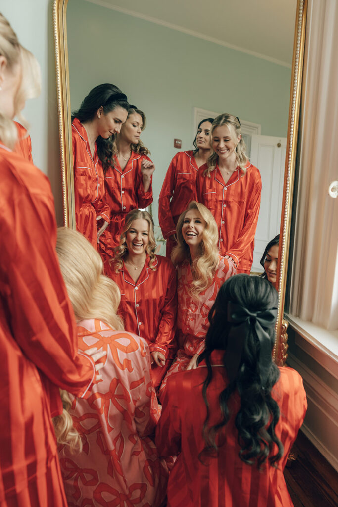 bridesmaids wear red matching pajamas at The Merrimon-Wynne House