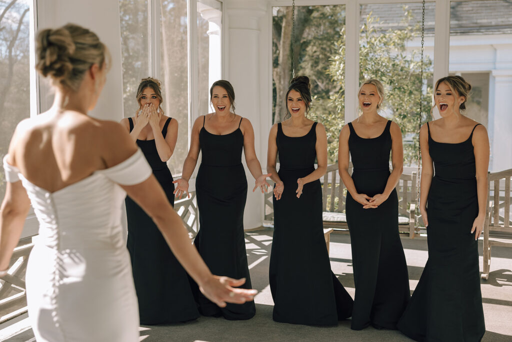 bride does first look with bridesmaids 