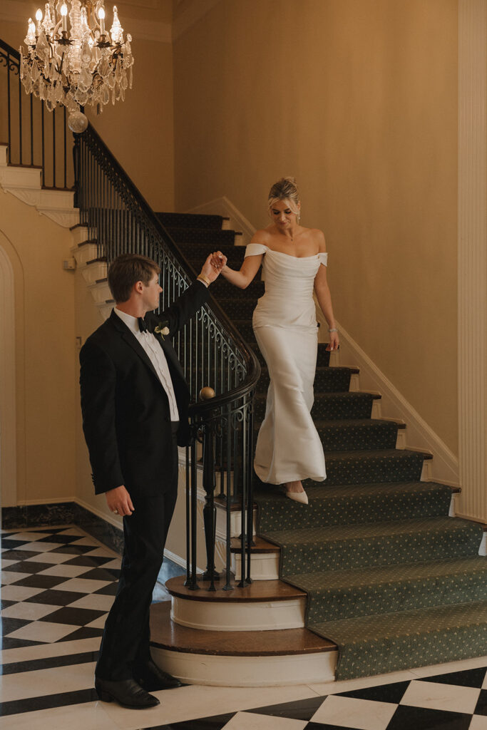 couple walks down staircase at The Duke Mansion Charlotte