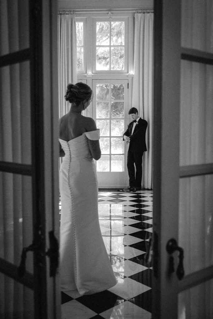 couple poses on black checkered floor at The Duke Mansion Charlotte