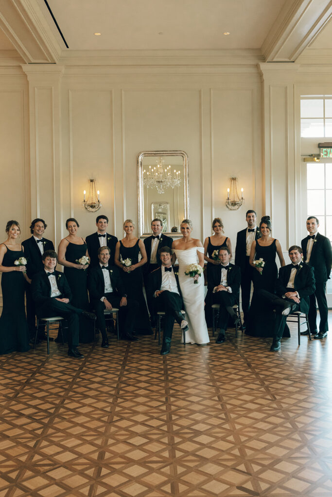 couple poses with wedding party at The Duke Mansion Charlotte