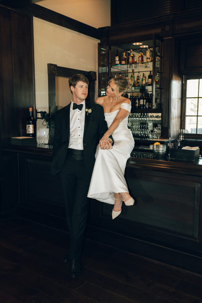 couple sits on bar at The Duke Mansion Charlotte