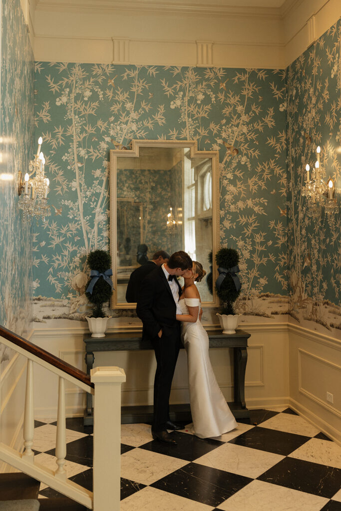 couple kisses in foyer of The Duke Mansion Charlotte