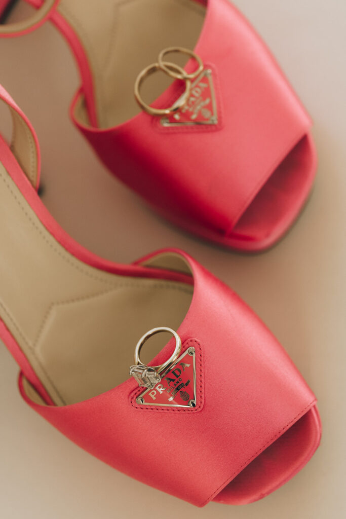 wedding bands on pink Prada wedding shoes 
